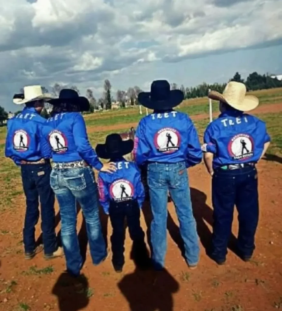 camisas vaqueras Tret en color azul rey personalizadas para team huesca y el equipo posa para mostrar las camisas en un entorno de campo